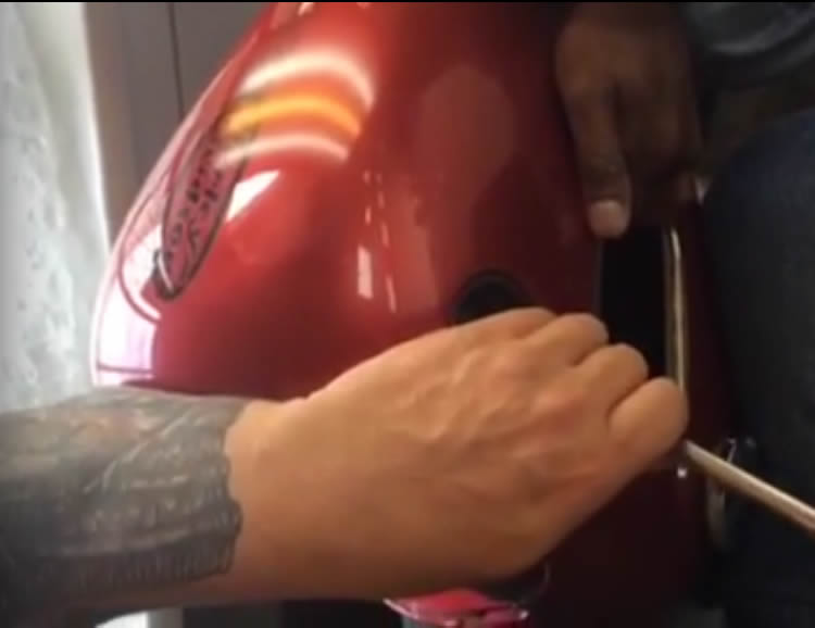 Motorcycle gas tank paintless dent removal in South Africa.